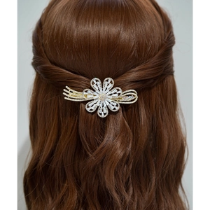 Elegant gold flower hair clip with zircon crystal diamonds on brown hair