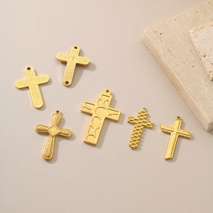 Collection of vintage gold titanium steel cross pendants in various engraved designs