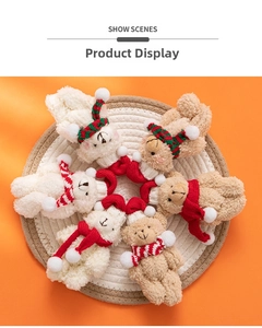 Close-up of Christmas plush bear and rabbit ornaments with festive scarves and hats