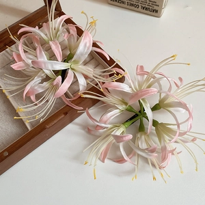 Close-up of pink silk Lycoris hair clip showing realistic petals and satin texture