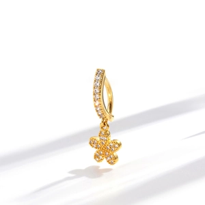 Elegant gold navel piercing belly ring with sparkling zircon flower pendant on white background