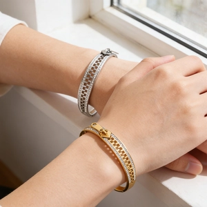 Detail of creative zipper design bangle with sparkling pavé cubic zirconia on wrist