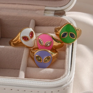 Set of four gold 18K plated alien rings with colorful enamel faces in a jewelry box