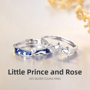 Macro view of 925 silver couple rings featuring blue starry fox and rose design