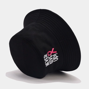 Detail of 'NEVER GIVE UP' embroidery and pink ribbon icon on black cotton bucket hat