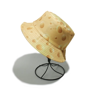 Close-up of cheese pattern canvas bucket hat with realistic yellow print and metal stand