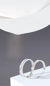 Close-up of luminous star-shaped 925 silver couple rings showing glow effect in dark