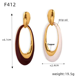 Detail view of oval copper earrings with burgundy and cream drip oil enamel and dimensions
