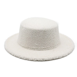 Detail of white sherpa fleece flat top hat showing thick texture and winter warmth