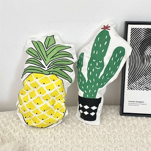 Creative pineapple and cactus shaped decorative throw pillows on soft white faux fur rug