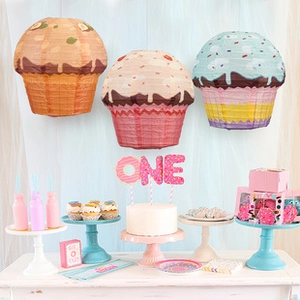 Hanging cupcake-shaped paper lanterns in pastel colors for sweet birthday party decor