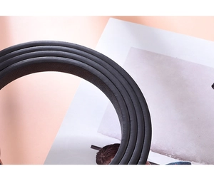 Macro shot of black leather belt detailing high-quality texture and sealed edge craftsmanship