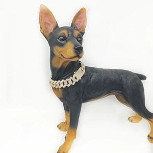 Detail of a 20mm triple row rhinestone Cuban necklace on a brown dog statue