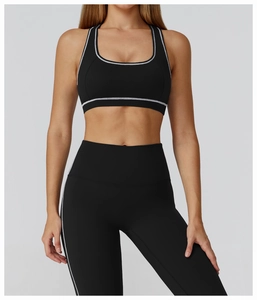 Detail of high-elasticity racerback sports bra and leggings with contrast white piping