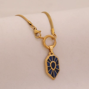 Detail of gold snake chain with blue enamel hexagonal pendant and spring clasp