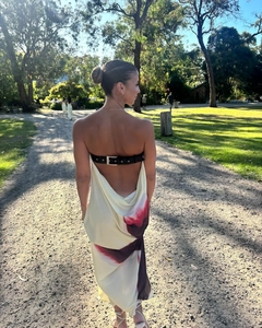 Detail of elegant backless printed maxi dress featuring black leather buckle back strap