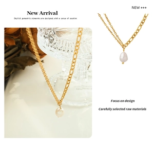 Detail view of 18K gold double chain necklace featuring an irregular baroque pearl