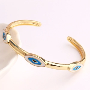 Adjustable gold cuff bracelet featuring three colorful enamel evil eye charms for women