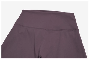 Detail view of deep purple high-waisted yoga pants with durable flatlock double stitching