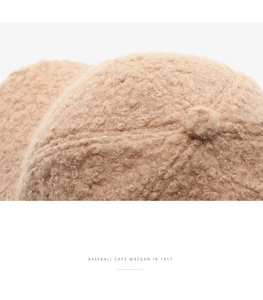Close-up of beige sherpa baseball cap showing textured fleece material and top button detail