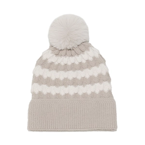 Detailed view of striped knit beanie with soft pom-pom and wide ribbed cuff texture