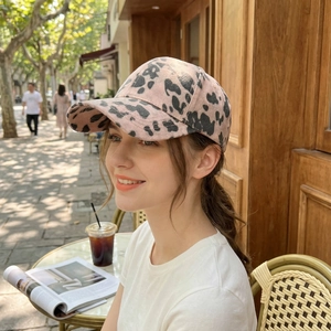 Pink and black cow print baseball cap with classic six-panel structure for outdoor style