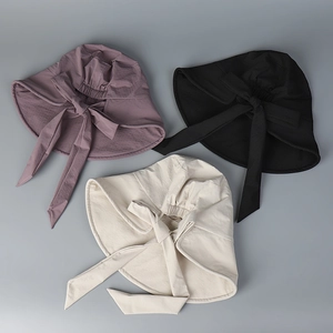Rear view of three sun hats with large bows and elastic adjustment in various colors