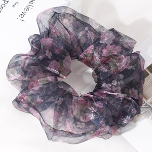 Macro detail of oversized organza hair scrunchie with dark blue and pink floral print