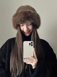 Close-up detail of plush brown faux fur texture on a warm winter bucket hat for women