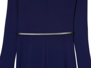 Detailed view of dark blue pleated dress featuring a slim black leather waist belt