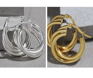 Close-up of triple-layered S925 silver hoop earrings in gold and silver finishes