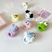 Macro shot of handmade crochet animal finger puppets in soft colorful chenille yarn