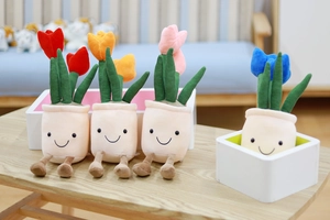 Detailed view of four colorful plush tulip potted plants with smiling faces on a wooden table