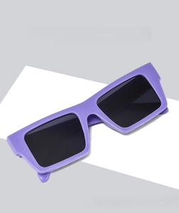 Detail view of purple rectangular sunglasses with thick frame and dark Y2K lenses
