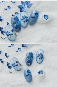 Detailed blue lotus and butterfly nail decals shown on transparent and blue tips