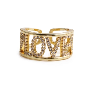 Detail of gold LOVE letter ring with micro-paved white zircons and open design