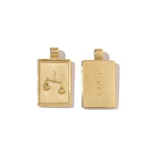 Detailed view of gold Libra zodiac rectangle pendants with embossed patterns and engraving