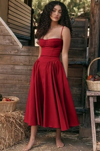 Detail of red satin French vintage dress set with crop top and long skirt in farm setting