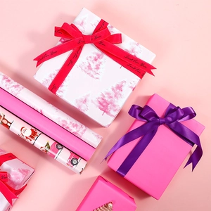 Pink Christmas gift wrapping paper roll set with Santa Claus and festive tree patterns