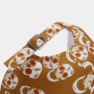 Detail of adjustable metal buckle and red-eyed skull print on brown baseball cap