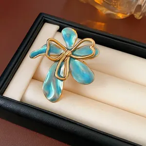 Vintage floral open ring with iridescent blue petals and golden metallic edges