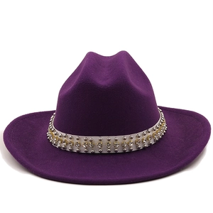 Close-up of purple wool felt fedora featuring white sequin and silver rivet band detail