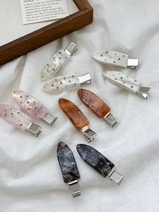 Detail of 10-piece rhinestone waterdrop hair clips with vintage acetate marbling textures