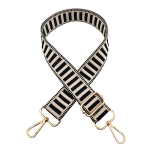 Adjustable black and white striped canvas bag strap with gold metal swivel snap hooks