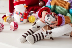 Plush brown and white striped thermal coral fleece socks in a festive round gift box