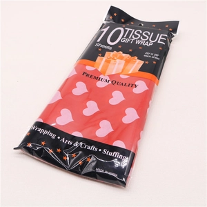 Detail of 10 red tissue paper sheets with pink hearts for gift wrapping and crafts