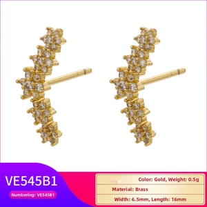 Detail view of 18K gold plated brass star-shaped earrings with clear crystal accents
