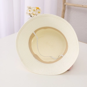 Detail of breathable straw sun hat interior featuring a sweatband and elastic wind rope