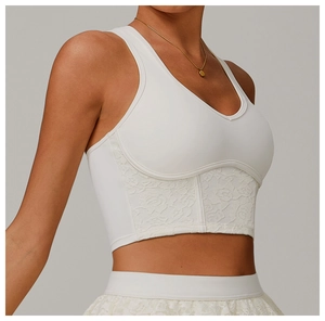 Detailed side view of white yoga tank top featuring elegant floral lace trim and mesh fabric