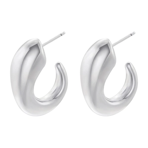 Macro shot of silver-colored geometric C-shape earrings with a polished mirror finish